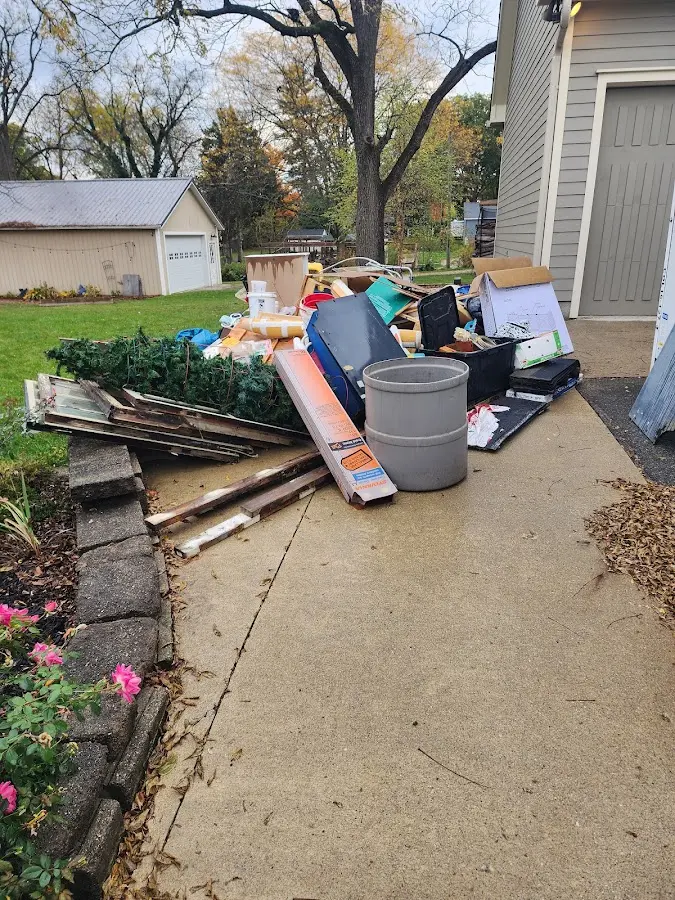 Dumpster being loaded with debris for Estate Cleanout Dumpster Rental in Davison